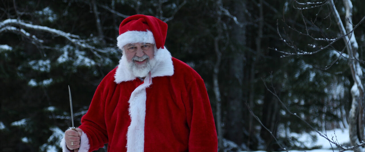 Santa (Pierse Stevens) in the snow from Nightmare on 34th Street, Christmas horror anthology exploring [keywords: festive terror / winter horror / holiday nightmare]