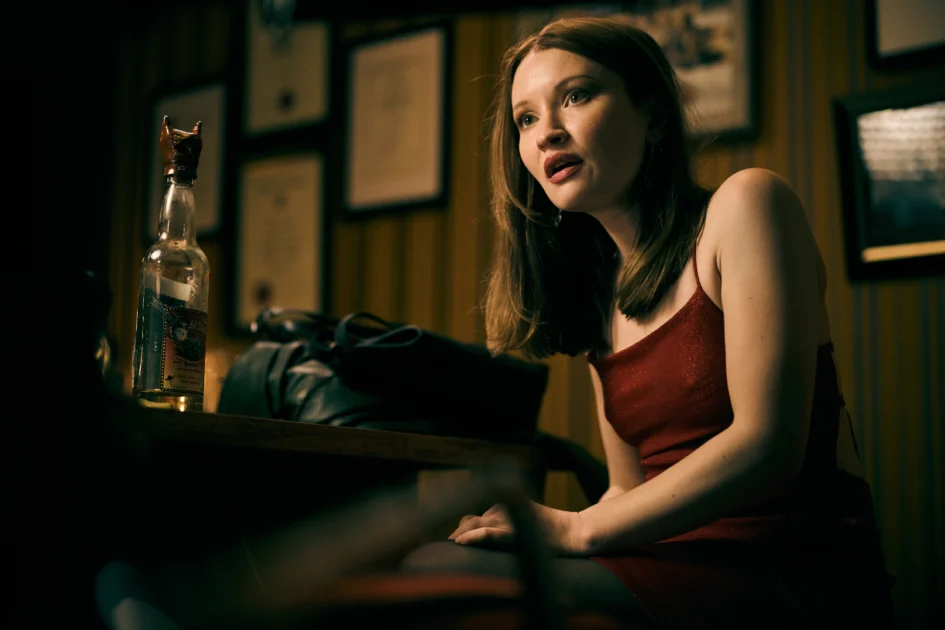 Emily Browning as Minnie in One More Shot with her bottle of tequila.