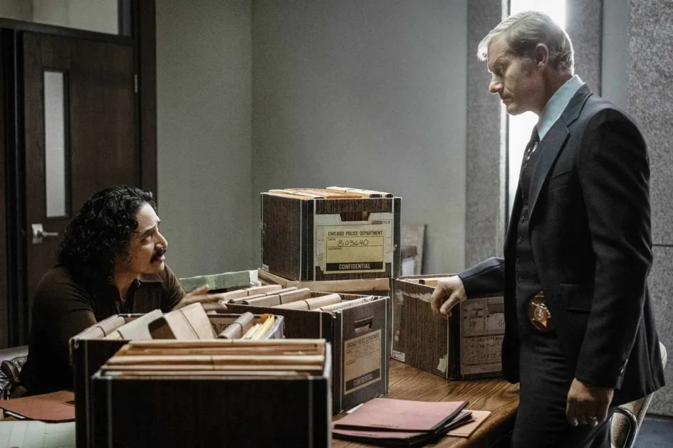 [Devil in Disguise] Detectives Rafael Tovar (Gabriel Luna) and Joe Kozenczak (James Badge Dale) reviewing case files in dimly lit police precinct