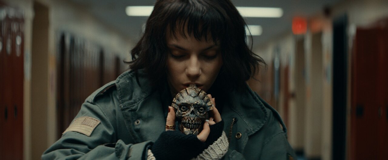 Dafne Keen as Chrys Willet holding ancient whistle in horror film Whistle