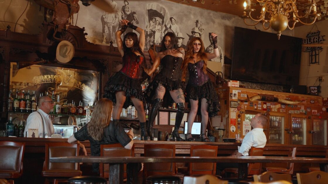 Nina Lanee Kent's Scarlett orchestrates a social media empire built on vampire seduction in Only Fangs, Paul Ragsdale's chaotic indie satire about corporate excess and predatory power dynamics.